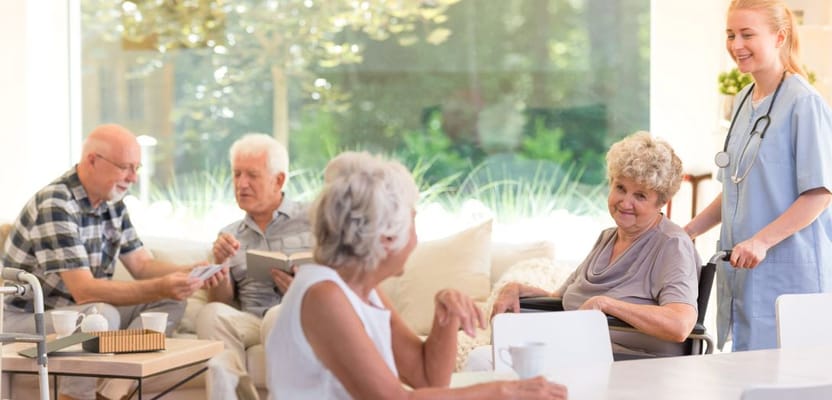 Residents engaging with staff and each other in a bright common area