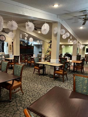 Dining room with holiday decorations and seating at Pine Ridge of Hayes