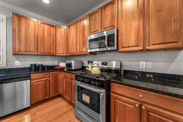 Interior kitchen space with wooden cabinets and appliances