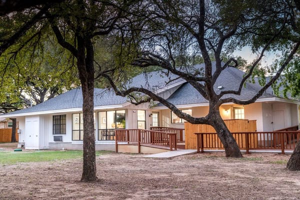 Exterior view of an assisted living facility with trees