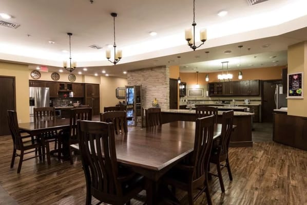 Spacious dining area with wooden tables and chairs.