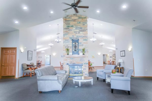 Bright common area with seating and a fireplace