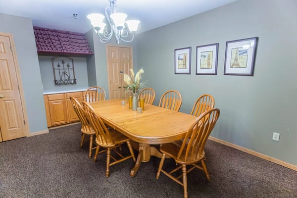 Dining area with a large wooden table and chairs