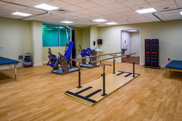 Interior view of therapy room with exercise equipment and therapy bars