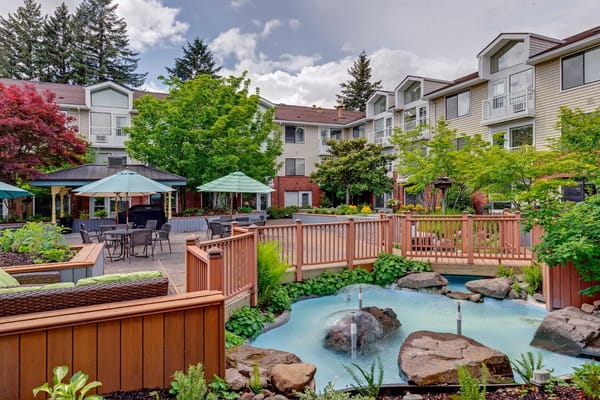 Beautifully landscaped outdoor space with a pond and seating area