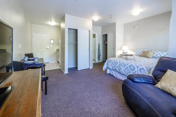 Comfortable resident room with a bed and sitting area