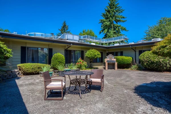 Outdoor patio space with seating and landscaping