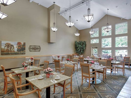 Bright dining room with tables set for meals