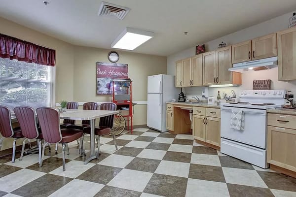 Bright kitchen area with dining table and appliances