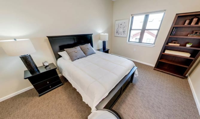 Cozy private resident room with bed and bookshelf