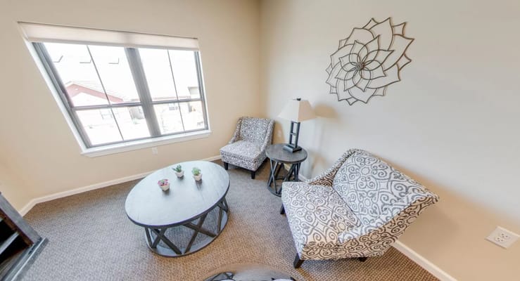 Cozy sitting area with patterned chairs and a coffee table