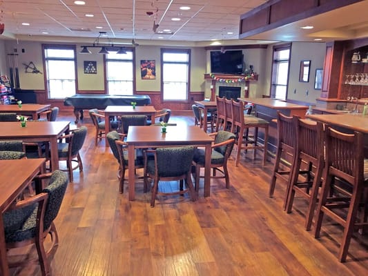 Interior view of a dining area with wooden tables and chairs