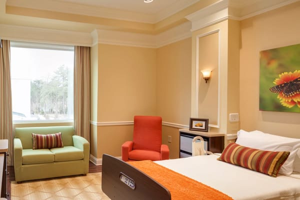 Cozy resident room with a bed and seating area