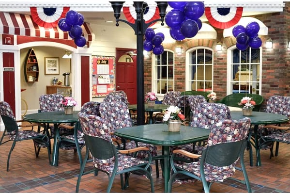 Brightly decorated common area with seating and balloons