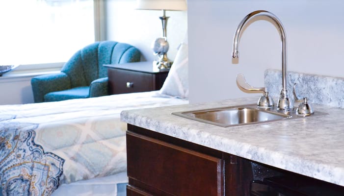 Interior view of a resident's room with kitchenette