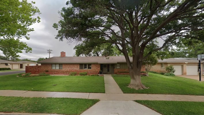 Exterior view of an assisted living facility with landscaped front yard