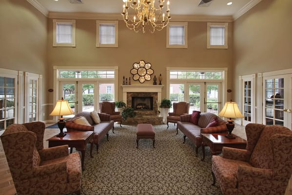 Bright common area with comfortable seating and a fireplace