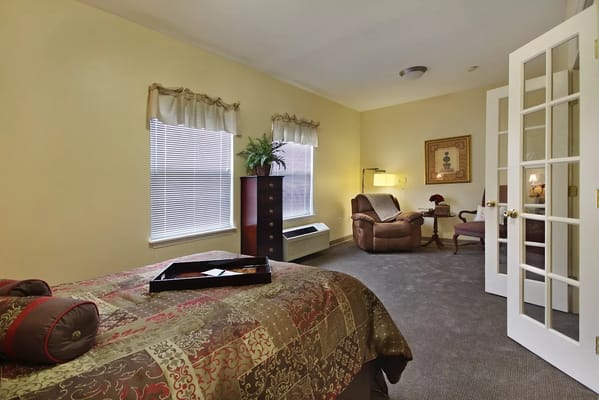 A cozy resident room with furniture and windows