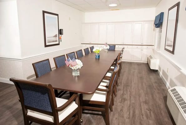 Common area with a long dining table and chairs