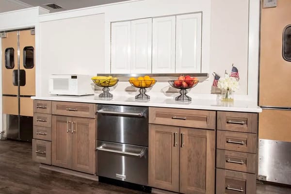 Modern kitchen area with fresh fruit and microwave