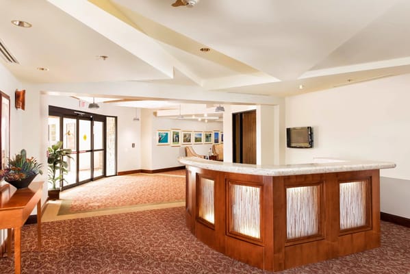 Bright lobby area with reception desk and comfortable seating