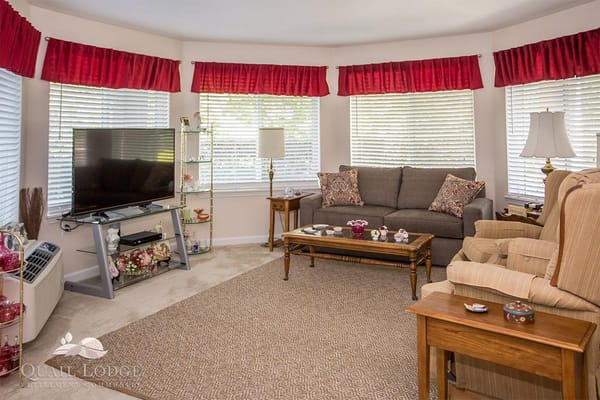 Living room with comfortable seating, television, and decorative accents