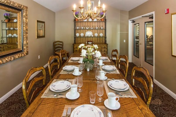 Elegant dining room with a long wooden table set for meals