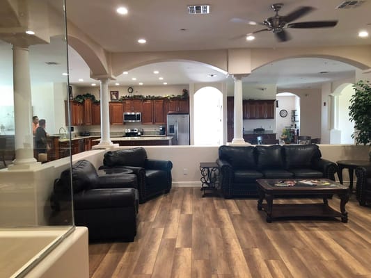 Interior view of a common area with seating and kitchen