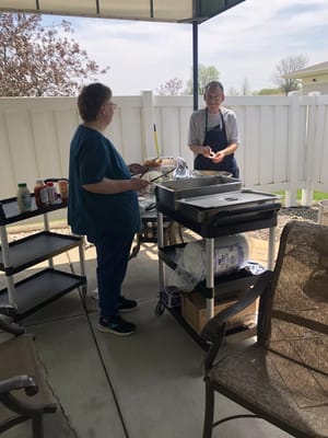 Residents enjoying a barbecue activity outdoors