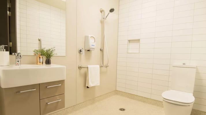 Modern bathroom with shower, sink, and toilet