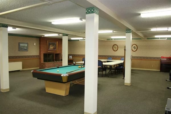Interior activity room with pool table and seating