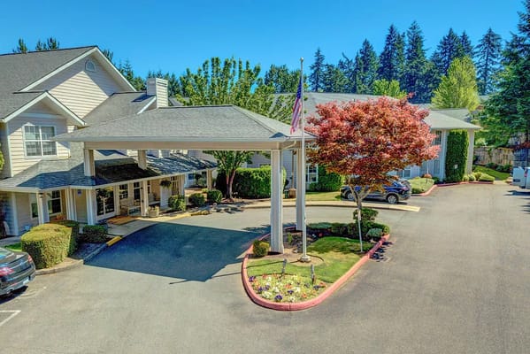 View of the entrance with a canopy and landscaping at Redwood Heights Assisted Living
