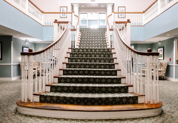 Staircase with carpet and wooden railings in Regal Estates