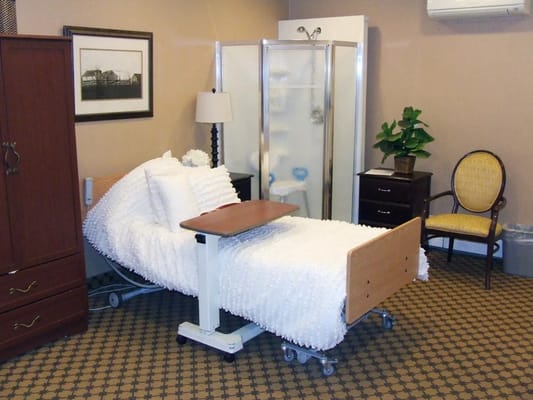 A well-furnished nursing room with a bed and shower