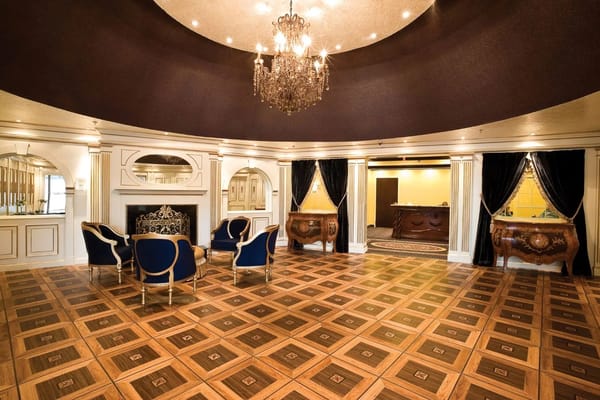 Elegant interior common area with chandeliers and chairs