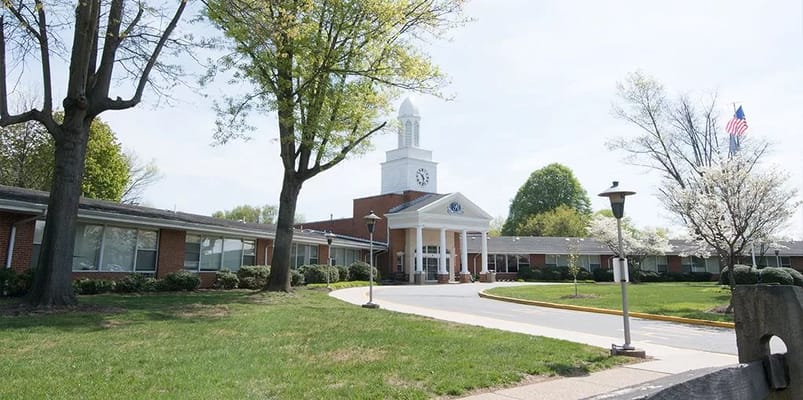 Front view of Regal Heights Healthcare facility with lawn and trees