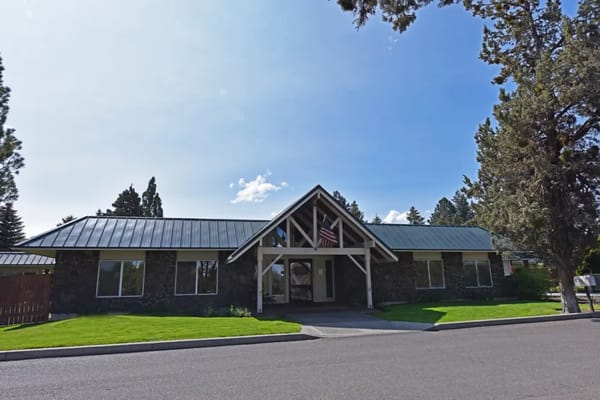 Front view of Regency Care of Central Oregon building with flag