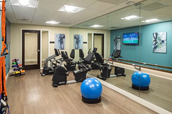 Fitness room with equipment and a large mirror