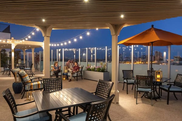 Outdoor terrace with residents enjoying the evening