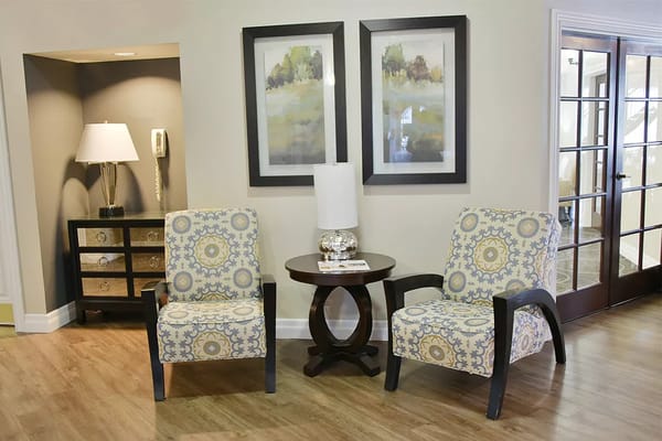 Comfortable seating in a living area with decorative lamps and artwork