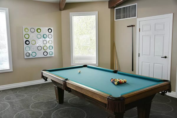 Pool table with balls arranged in a billiards room