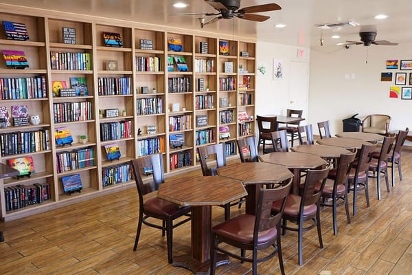 Library space with bookshelves and tables at Regent Villa