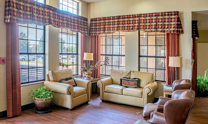 Interior lounge area with seating and large windows