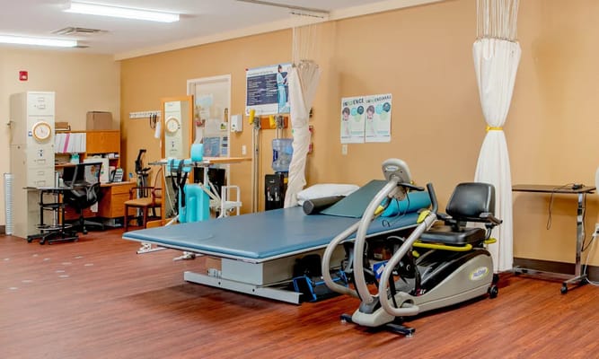 Rehabilitation room with therapy equipment and supplies