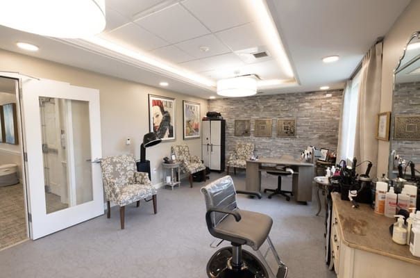 Interior view of a salon with chairs and styling stations.