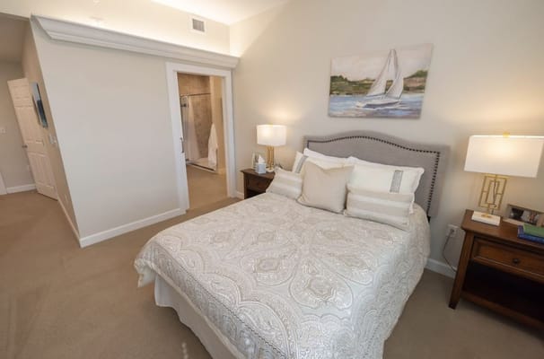 Brightly decorated bedroom with a queen bed and ensuite bathroom