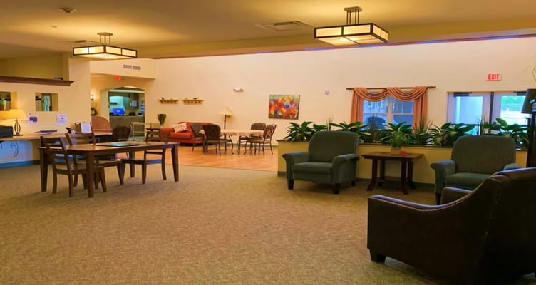 Common area with seating and decor in a senior living facility