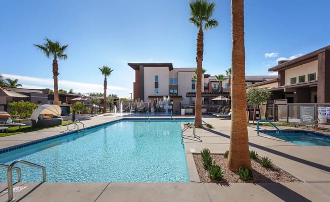 Outdoor swimming pool area with palm trees