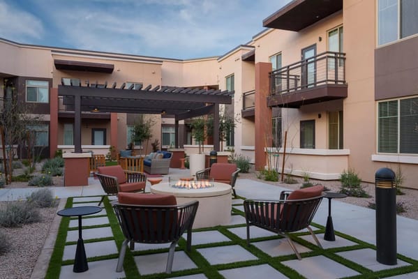 Outdoor seating area with fire pit and landscaping
