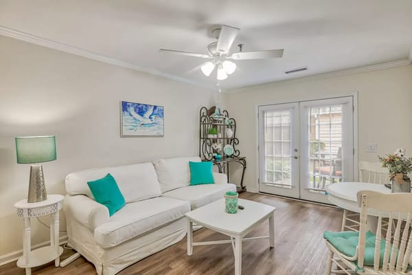 Bright and welcoming living area with white furniture